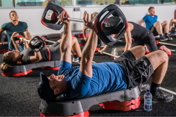 People bench pressing during a Revl Everest - high intensity interval training class at Christchurch Recreation and Sport centre.
