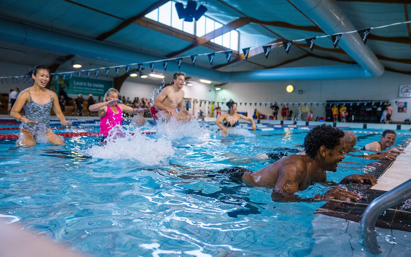 A group of eight adults participating in an Aqua Zumba class at Christchurch Recreation and Sport pool.