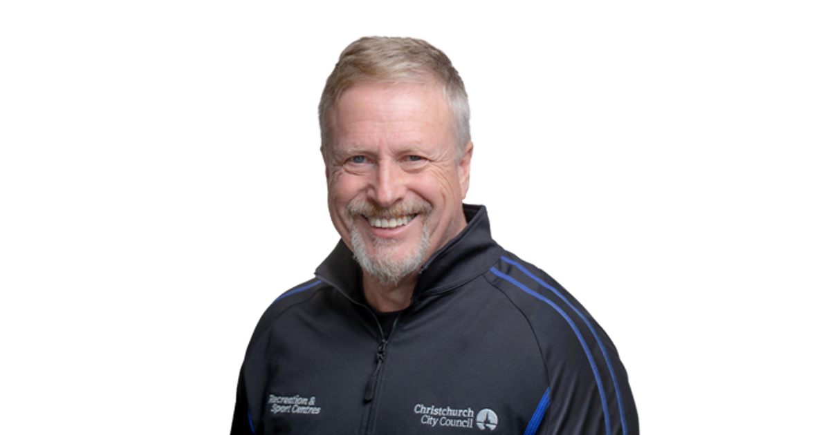 Smiling Personal Trainer, Stuart Dallow wearing and blue and black staff uniform.