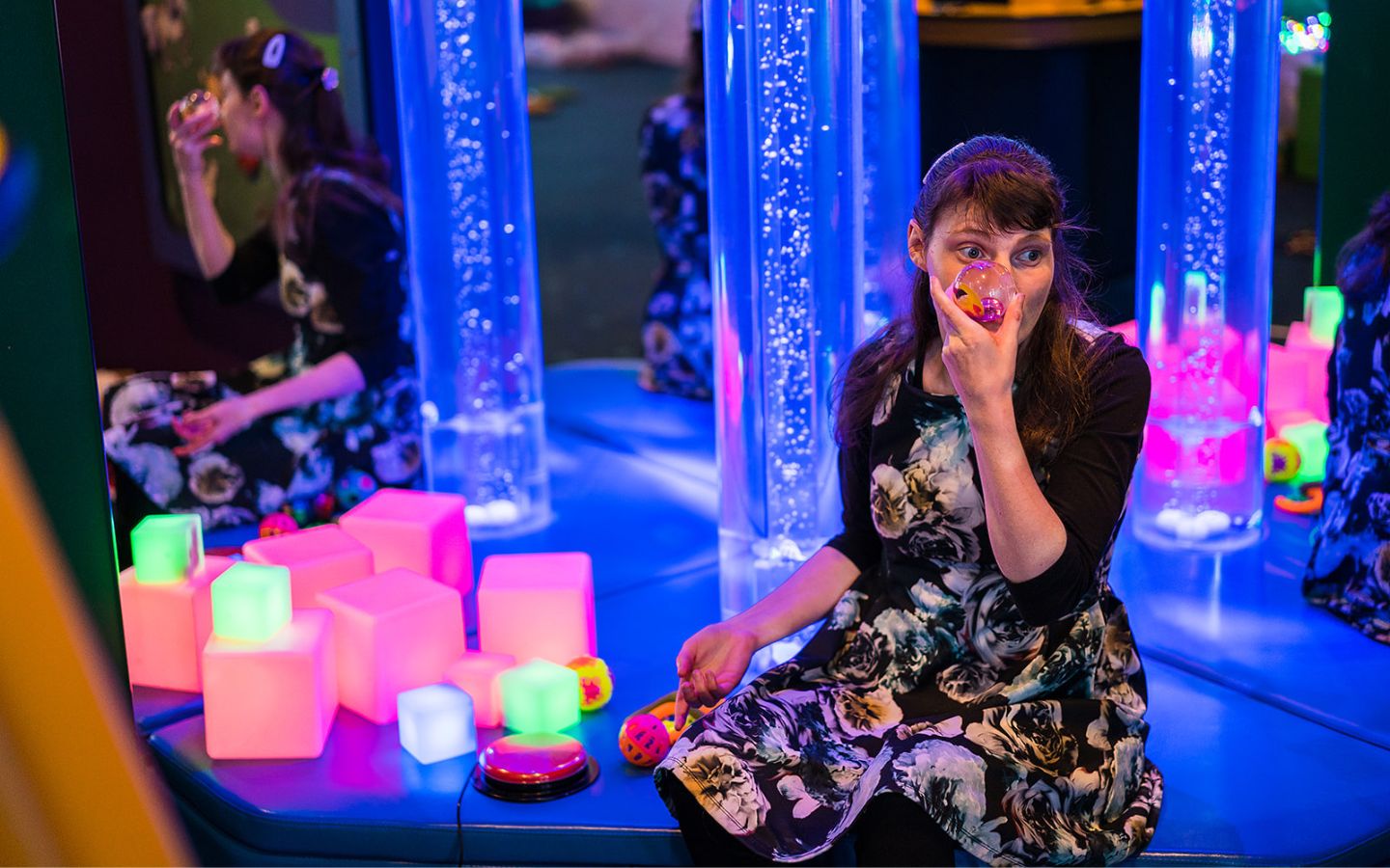A girl playing with some of the Multi-Sensory Experience glowing blocks at Pioneer Recreation and Sport centre. 
